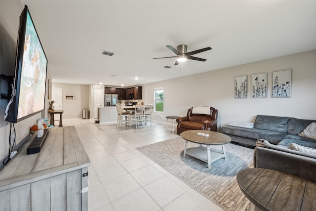 living room featuring light tile patterned flooring, a ceiling fan, baseboards, recessed lighting, and visible vents