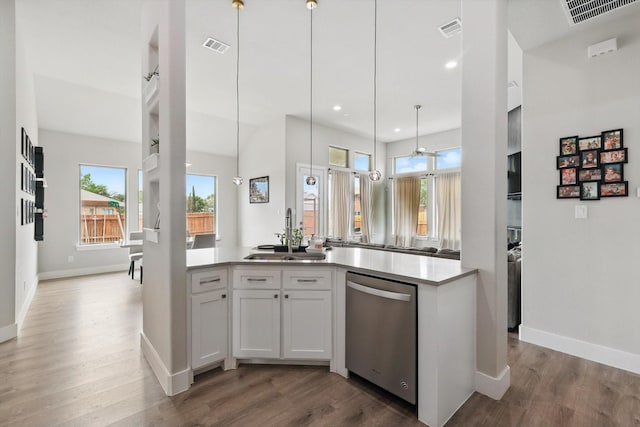 kitchen with visible vents, a sink, baseboards, and dishwasher