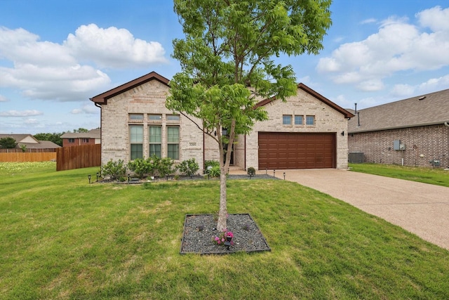 view of front facade with fence, an attached garage, a front lawn, brick siding, and driveway