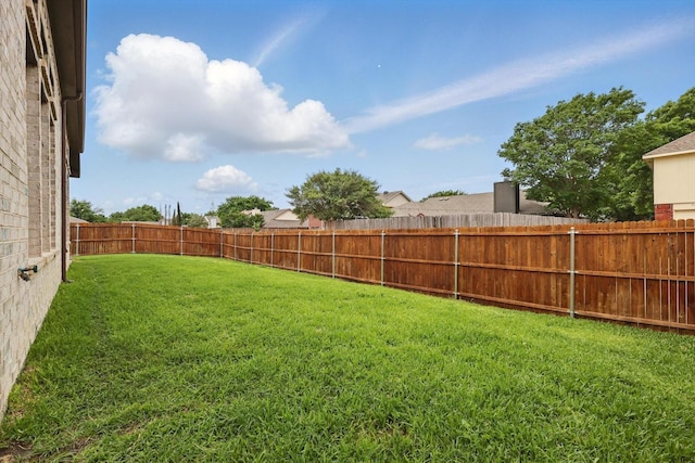 view of yard with a fenced backyard