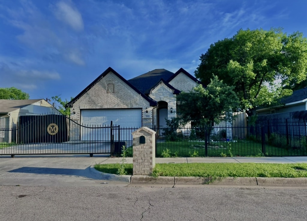 french country home with a garage, a fenced front yard, stone siding, and a gate