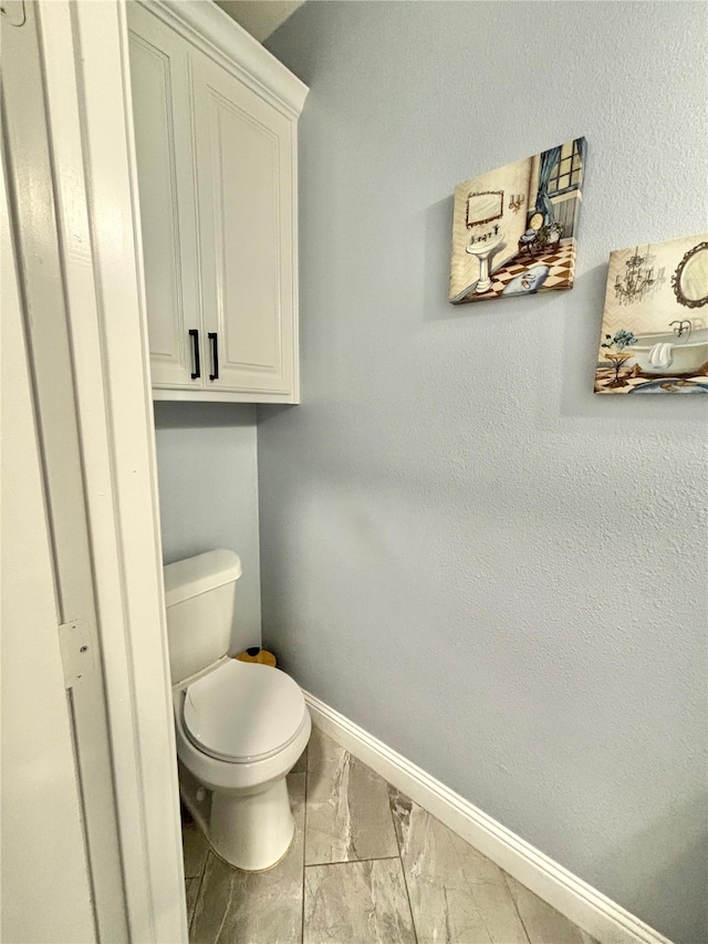 2512 Highcrest Ave, Fort Worth, TX 76111 - bathroom with marble finish flooring, baseboards, and toilet
