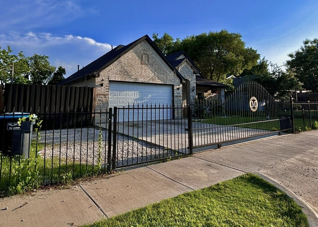 view of gate with a fenced front yard