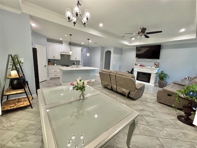 2512 Highcrest Ave, Fort Worth, TX 76111 - dining room featuring ornamental molding, a ceiling fan, a glass covered fireplace, a tray ceiling, and recessed lighting