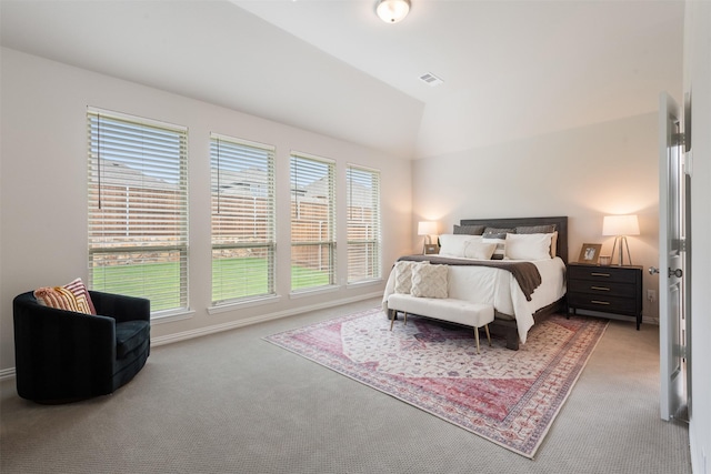 carpeted bedroom featuring baseboards, multiple windows, and vaulted ceiling