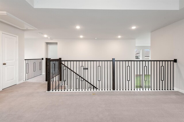 interior space with carpet flooring, recessed lighting, baseboards, and attic access