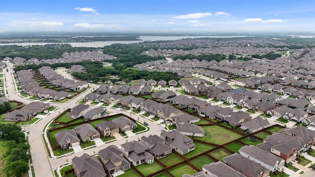birds eye view of property featuring a water view and a residential view