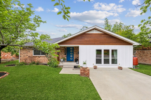 8545 Sweetwater Dr, Dallas, TX 75228 - view of front facade with a porch, a front yard, board and batten siding, and brick siding