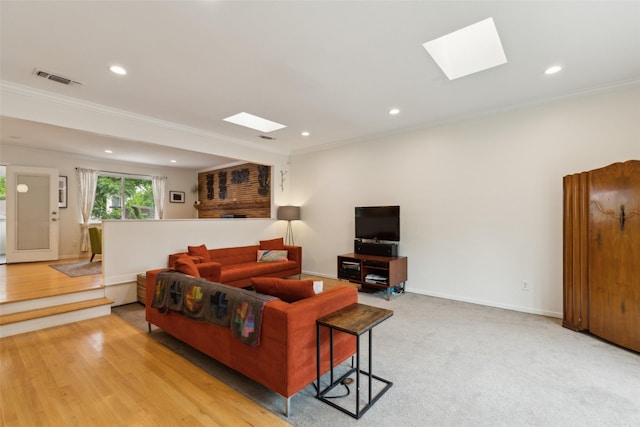 living area with recessed lighting, a skylight, visible vents, and ornamental molding