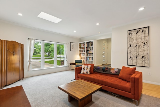 living area featuring recessed lighting, ornamental molding, baseboards, and a skylight
