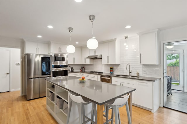 kitchen featuring a sink, dark countertops, decorative backsplash, and stainless steel appliances