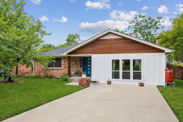 8545 Sweetwater Dr, Dallas, TX 75228 - view of front of house featuring board and batten siding, a front yard, and a chimney