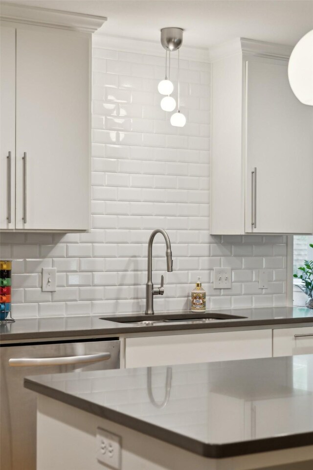 kitchen featuring backsplash, a sink, and dishwasher
