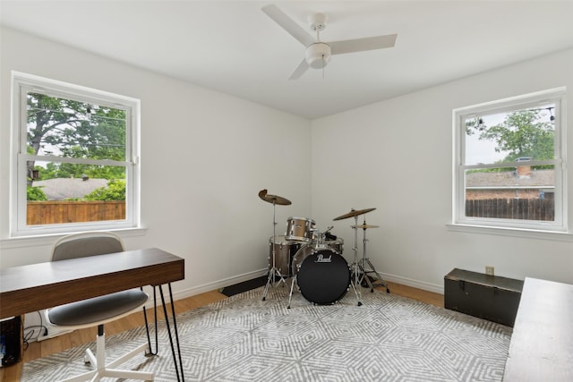 office area featuring plenty of natural light, a ceiling fan, and light wood-type flooring