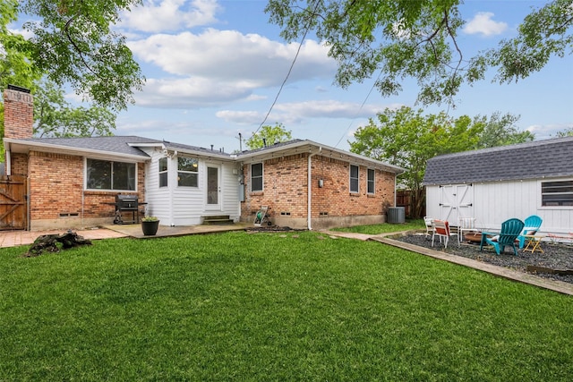 rear view of house featuring brick siding, central AC unit, entry steps, and a chimney