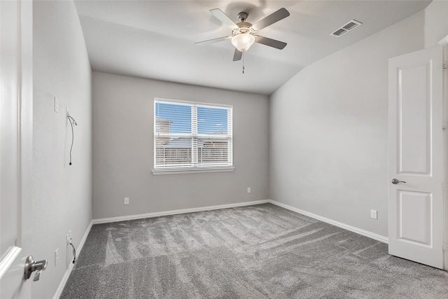 spare room featuring carpet, a ceiling fan, baseboards, lofted ceiling, and visible vents