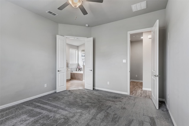 unfurnished bedroom featuring baseboards, visible vents, and carpet