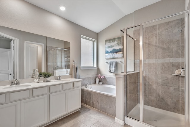 full bath featuring vaulted ceiling, a sink, a garden tub, and a stall shower