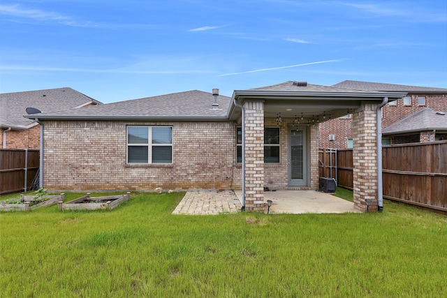 back of house with a patio, brick siding, and a fenced backyard