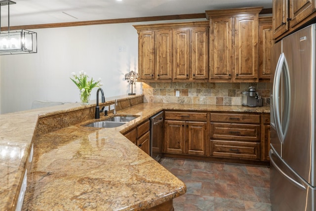 kitchen with decorative backsplash, stone finish flooring, a sink, light stone counters, and stainless steel appliances