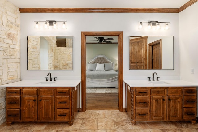ensuite bathroom featuring a sink, crown molding, a ceiling fan, and ensuite bath
