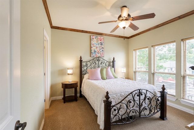 carpeted bedroom with baseboards, ornamental molding, and ceiling fan
