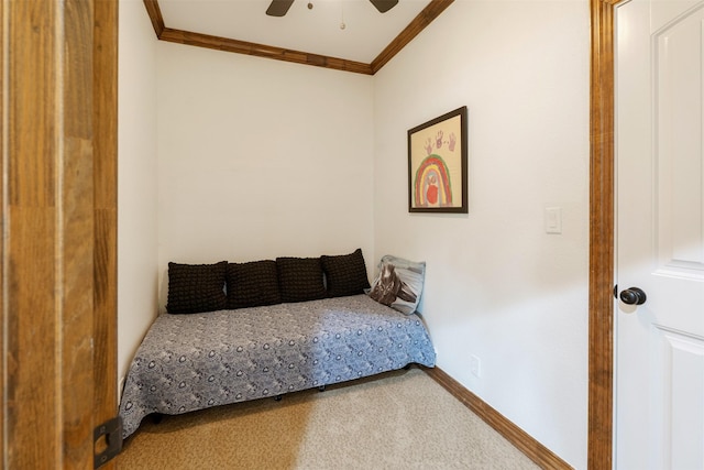 bedroom with crown molding, baseboards, ceiling fan, and carpet flooring