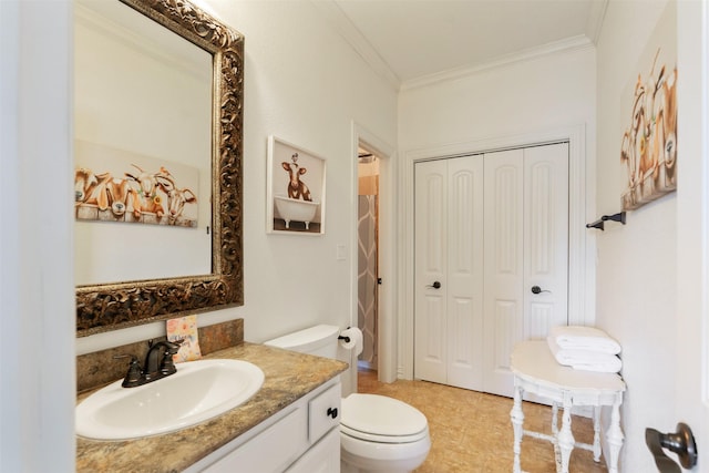 bathroom featuring crown molding, vanity, and toilet
