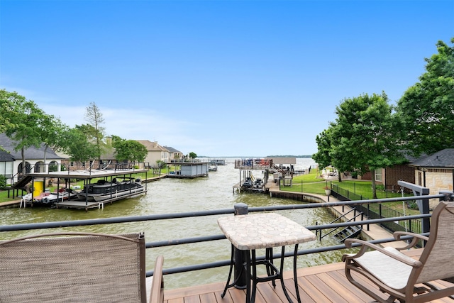 dock area with a water view and a balcony