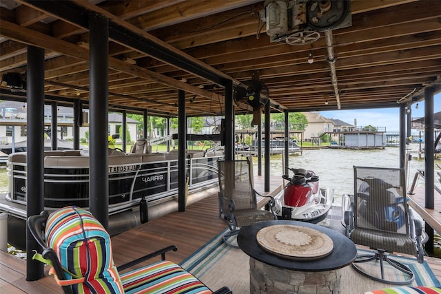dock area featuring boat lift and a water view