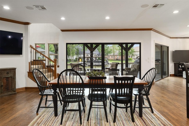 dining space with visible vents, ornamental molding, wood finished floors, baseboards, and recessed lighting