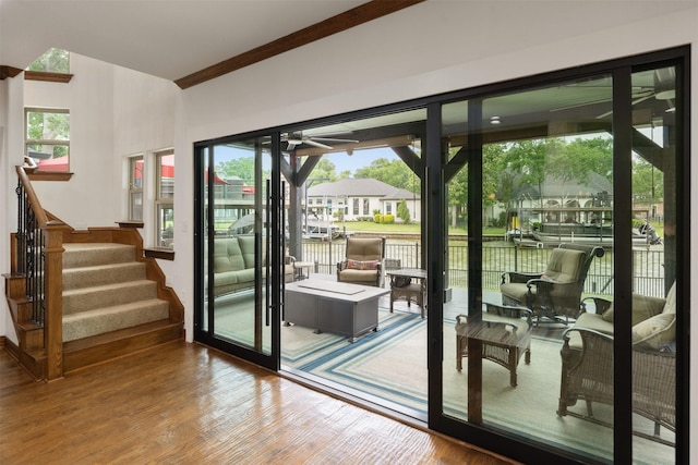 doorway to outside with stairway, ceiling fan, and wood finished floors