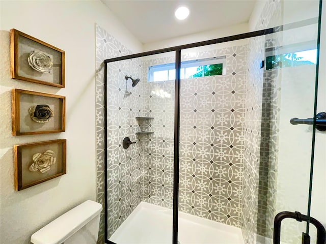 full bathroom with a shower stall and toilet