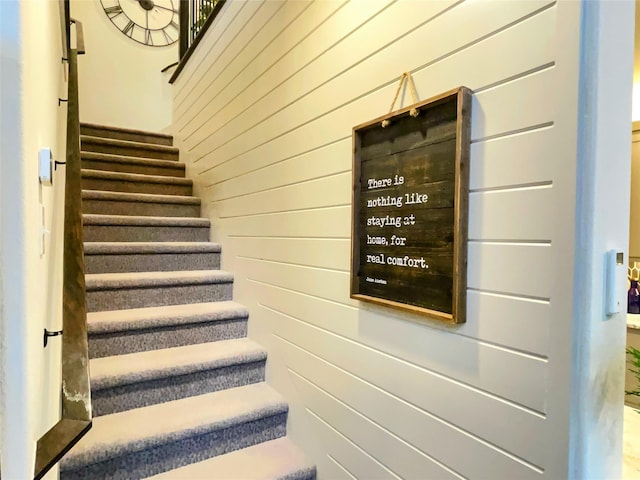 stairs featuring wooden walls