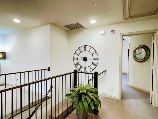 corridor featuring an upstairs landing, carpet flooring, visible vents, and recessed lighting