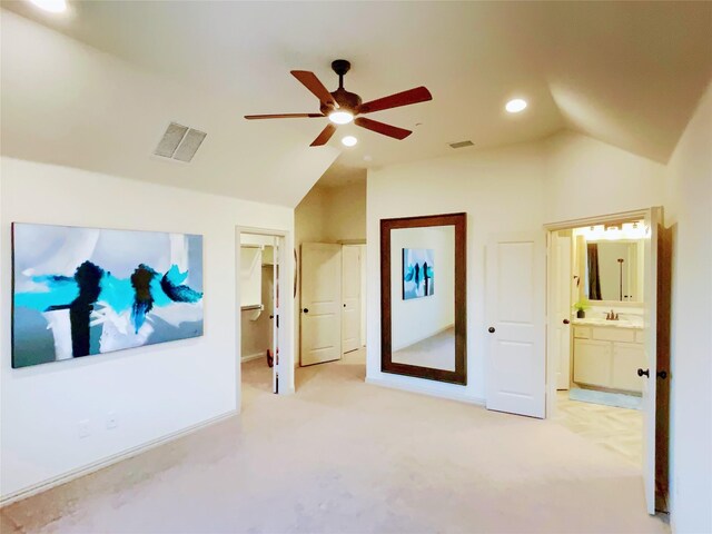 interior space featuring visible vents, lofted ceiling, a sink, and light carpet