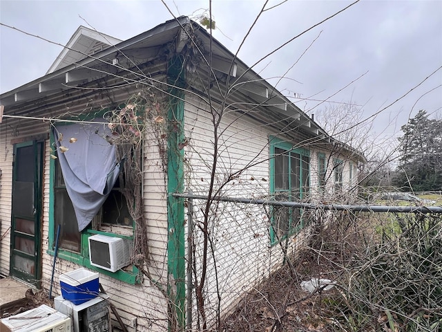 view of property exterior with fence and cooling unit