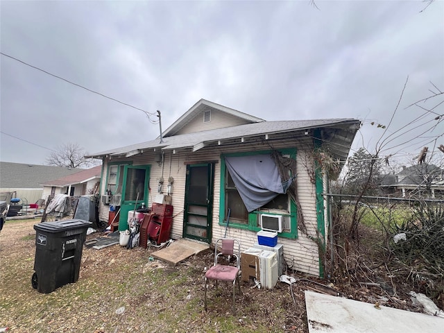 rear view of house featuring fence