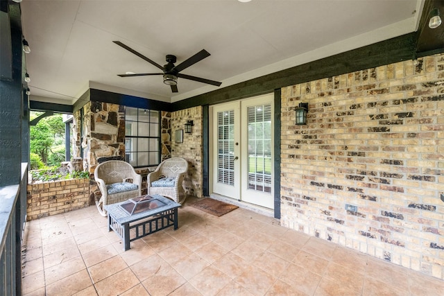 view of patio / terrace featuring french doors, ceiling fan, and a fire pit