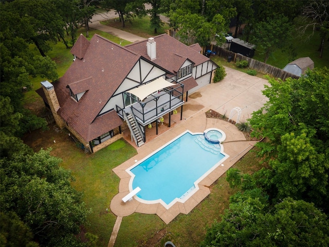 view of pool with stairs, a wooden deck, a fenced backyard, a patio, and a yard