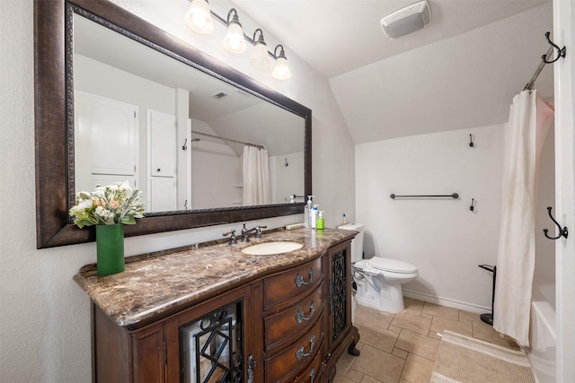 bathroom with visible vents, vanity, toilet, tile patterned floors, and vaulted ceiling