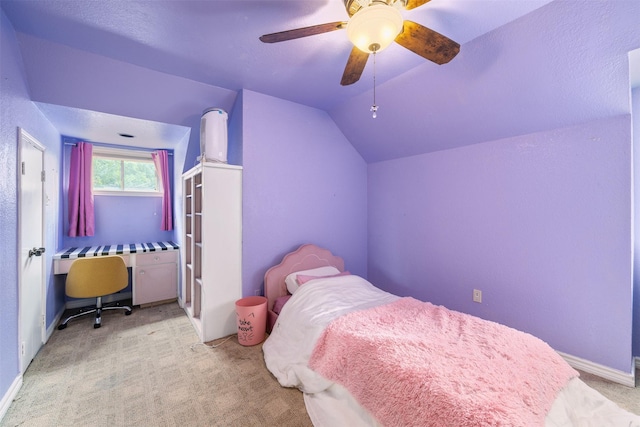 carpeted bedroom with baseboards, a ceiling fan, and vaulted ceiling