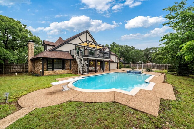 view of pool with stairs, a fenced backyard, a wooden deck, and a yard