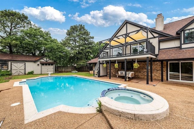 view of swimming pool with fence, a pool with connected hot tub, a patio, a deck, and an outdoor structure