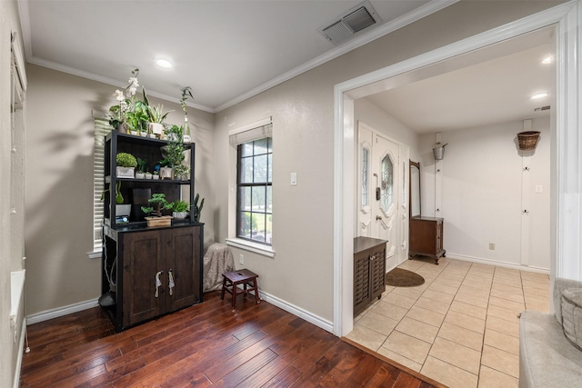 corridor with crown molding, wood-type flooring, recessed lighting, baseboards, and visible vents