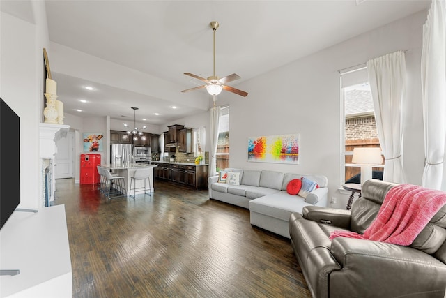 3608 Delta Dr, Mckinney, TX 75071 - living area with dark wood-style flooring, recessed lighting, a ceiling fan, a fireplace, and a chandelier