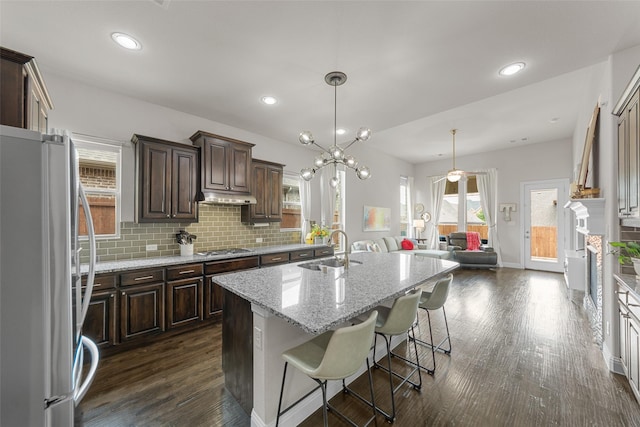 3608 Delta Dr, Mckinney, TX 75071 - kitchen featuring appliances with stainless steel finishes, a sink, dark brown cabinets, decorative backsplash, and dark wood-type flooring