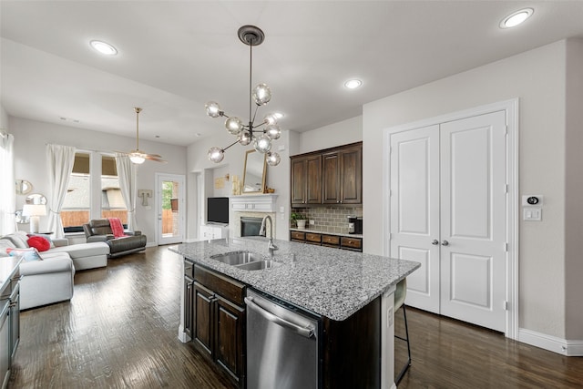 3608 Delta Dr, Mckinney, TX 75071 - kitchen featuring dishwasher, a sink, open floor plan, dark brown cabinets, and tasteful backsplash