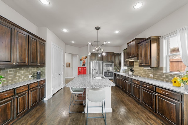 3608 Delta Dr, Mckinney, TX 75071 - kitchen with appliances with stainless steel finishes, a sink, dark brown cabinets, decorative backsplash, and a chandelier