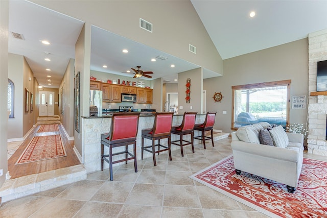 5553 Lakeshore Ct, Log Cabin, TX 75148 - kitchen featuring a kitchen breakfast bar, visible vents, dark countertops, appliances with stainless steel finishes, and open floor plan